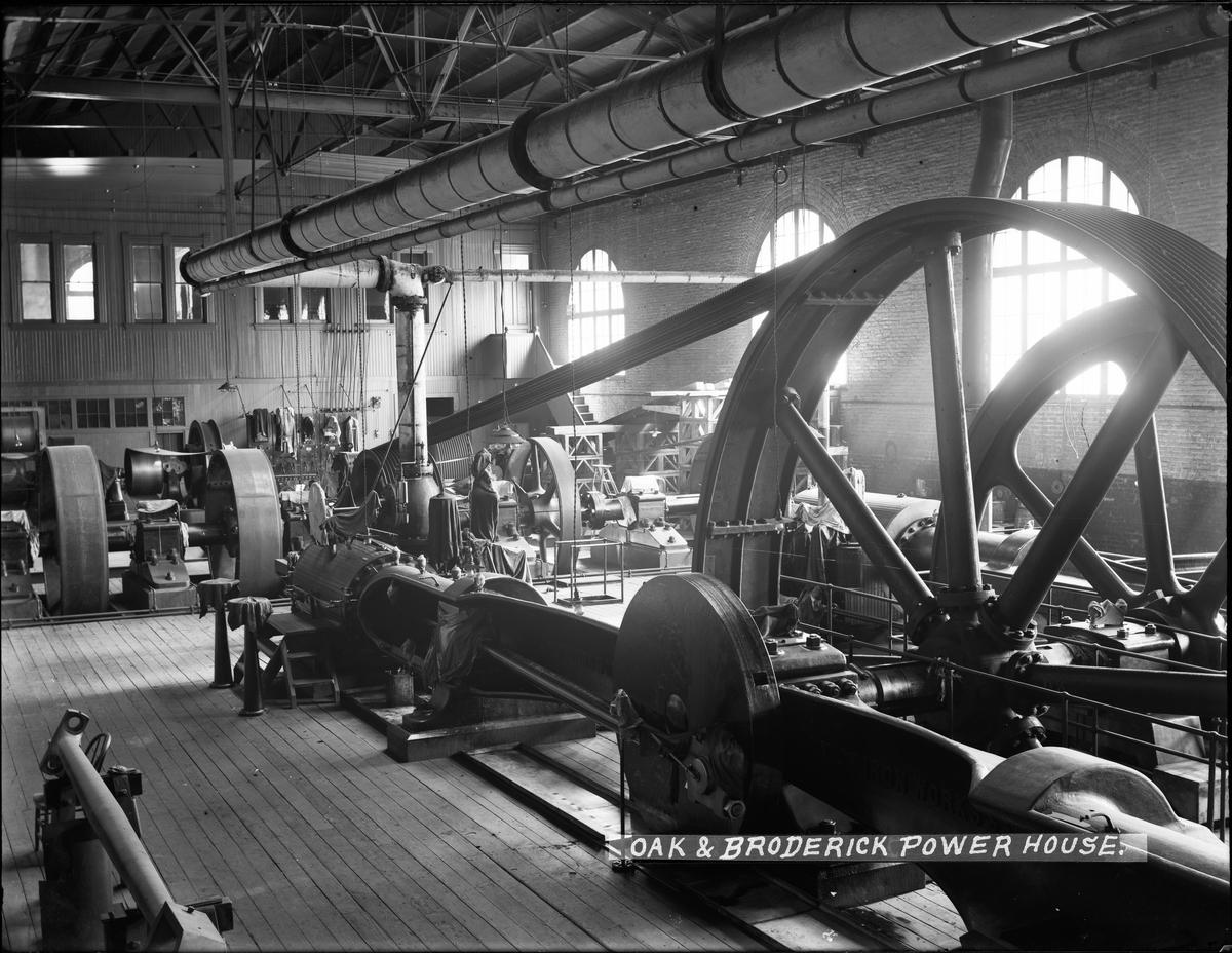 Historic steam engine machinery in industrial powerhouse with large flywheel and mechanical equipment, circa 1905.