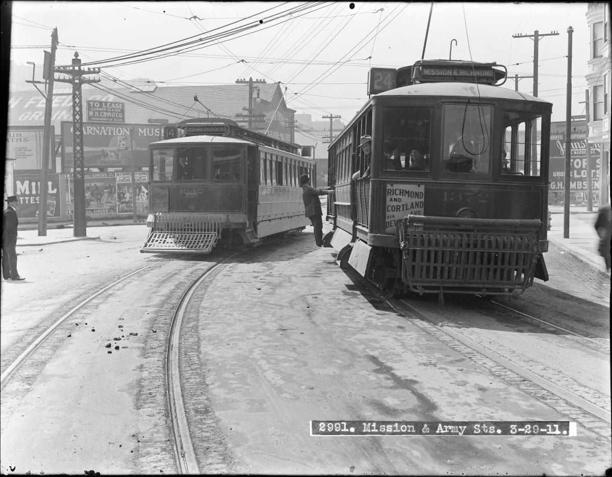 Two vintage streetcars on tracks at Mission and Army Streets intersection, San Francisco, 1911.