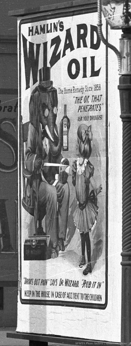 Vintage advertisement for Hamlin's Wizard Oil featuring illustrated figures and product bottles on a street sign.