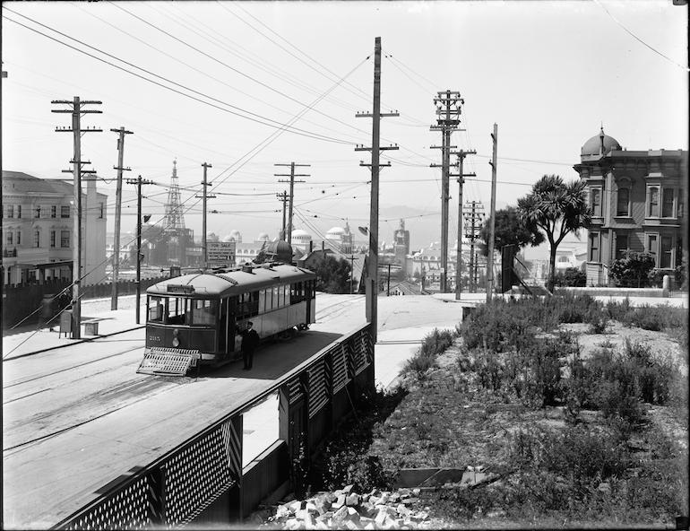 Streetcar 235 at Fillmore and Broadway Streets with Panama Pacific International Exposition visible in background, 1914.