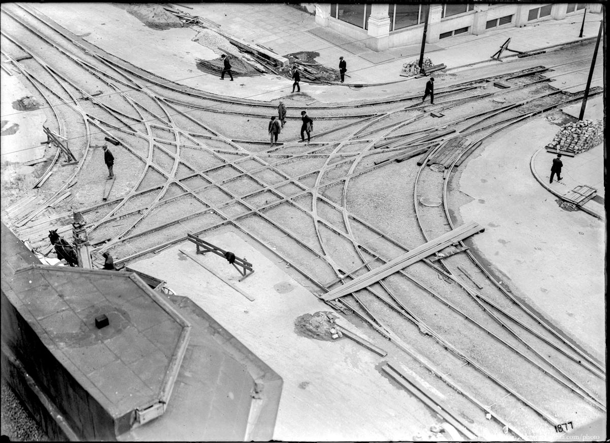 Aerial view of streetcar track construction junction with workers and equipment at Geary and Van Ness.
