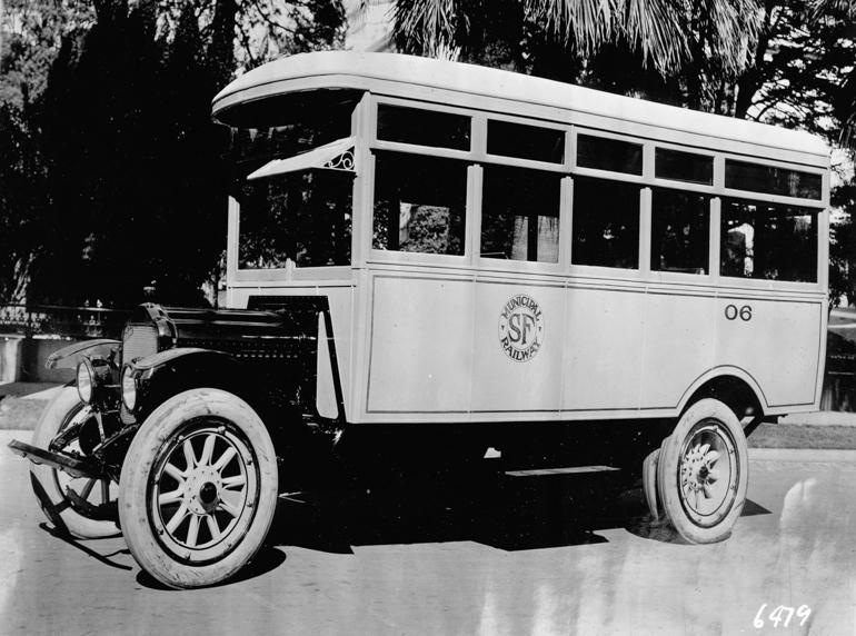 Vintage motor coach number 06 with curved roof and large windows, circa 1919.