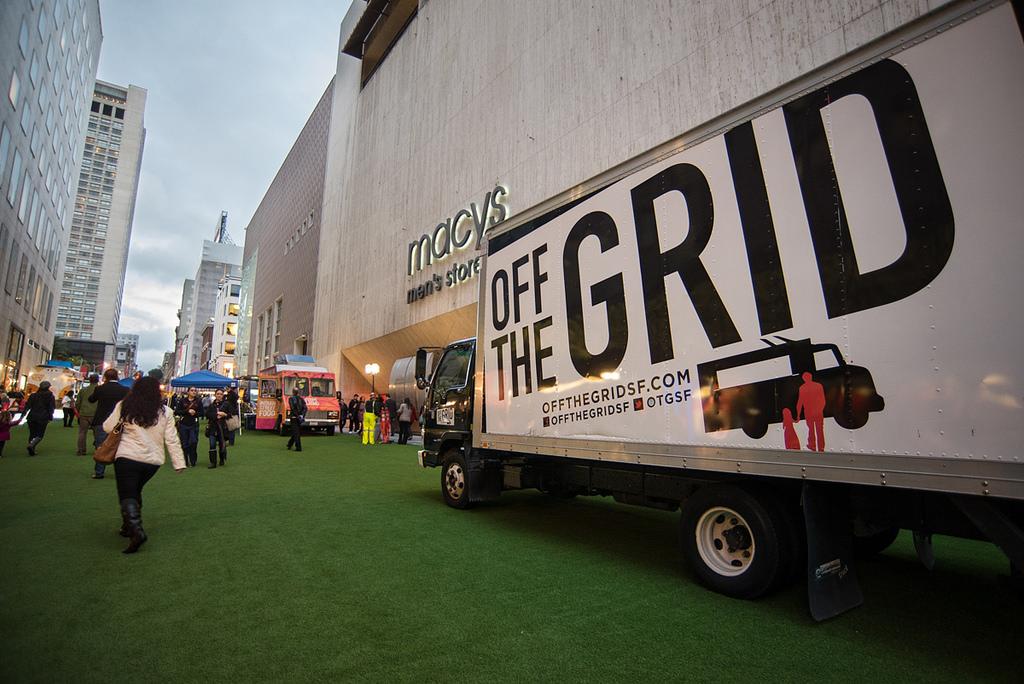 Off the Grid food truck parked on green astroturf in front of Macy's Men's Store in downtown San Francisco.
