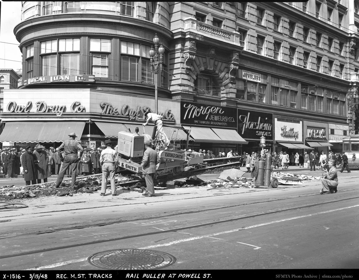 Rail puller removing streetcar tracks on Market Street at Powell Street, March 1948.