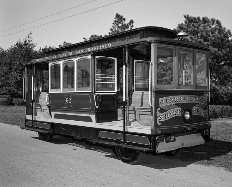 Motorized Cable Car 62, Municipal Railway of San Francisco, parked on street with trees in background, 1954.