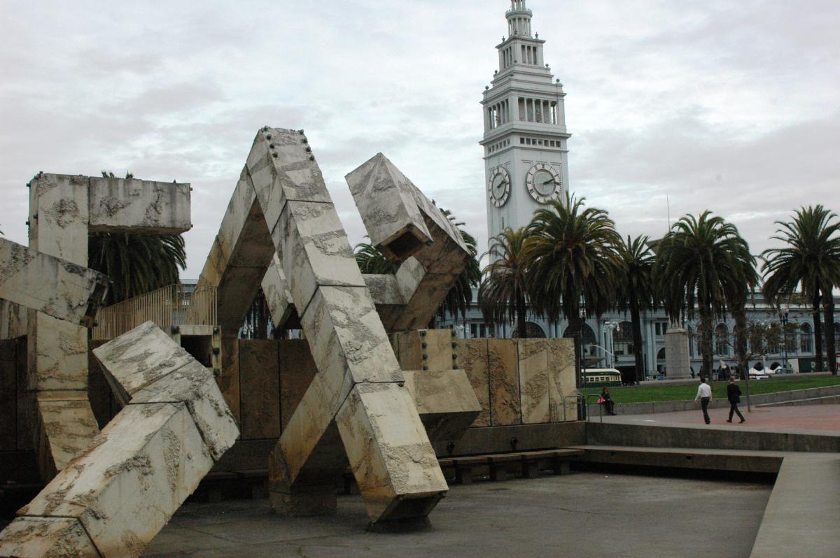 Vaillancourt Fountain with Ferry Building clock tower and palm trees in background, San Francisco Embarcadero.