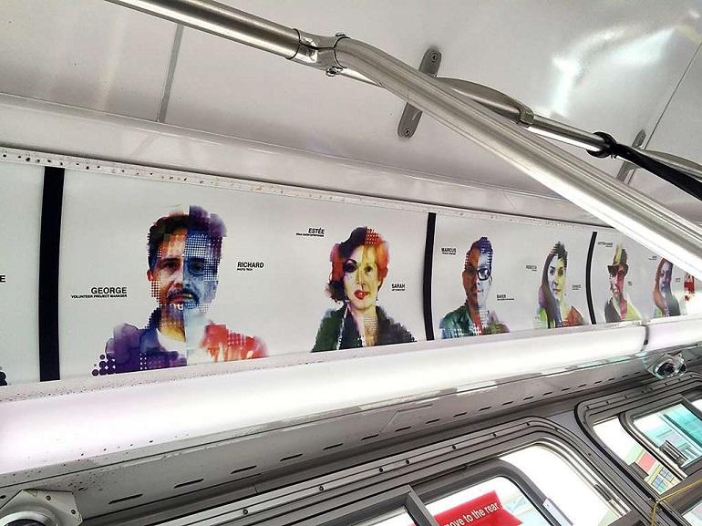 Colorful pixelated portrait artwork displayed on interior panel of public transit bus.