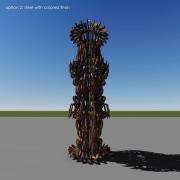 Tall abstract sculpture made of stacked dark materials against a clear sky and flat landscape.