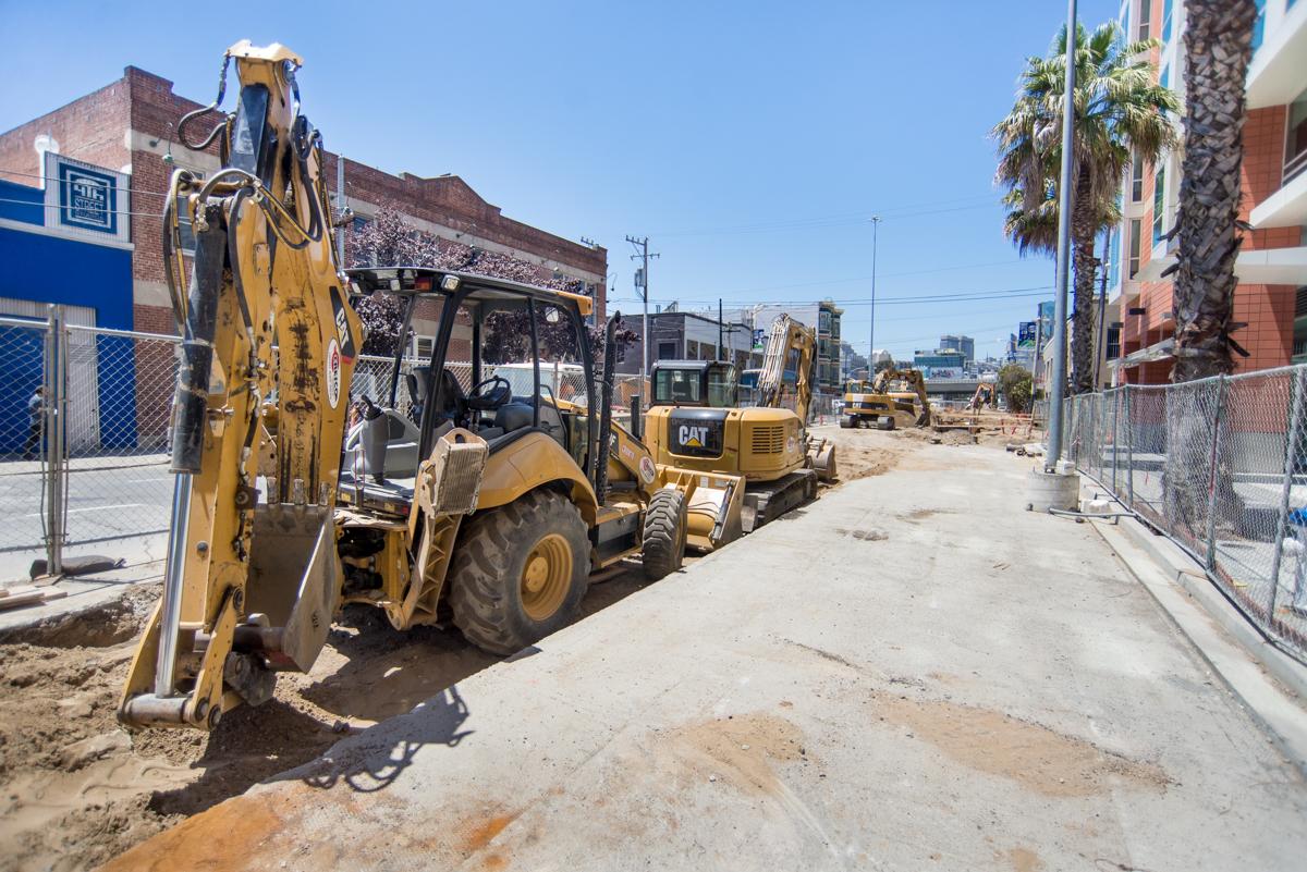 Construction equipment and machinery on 4th Street during utility and street restoration work.