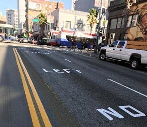 6th Street showing new road markings and signage for pedestrian safety zone and no left turn restrictions between Market and Howard.