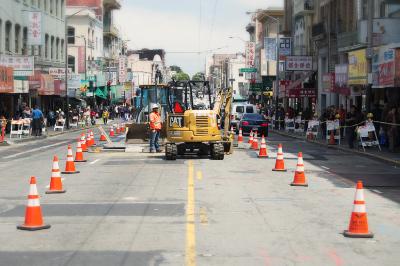 Construction equipment and traffic cones block Stockton Street during utility work between Sacramento and Jackson streets.