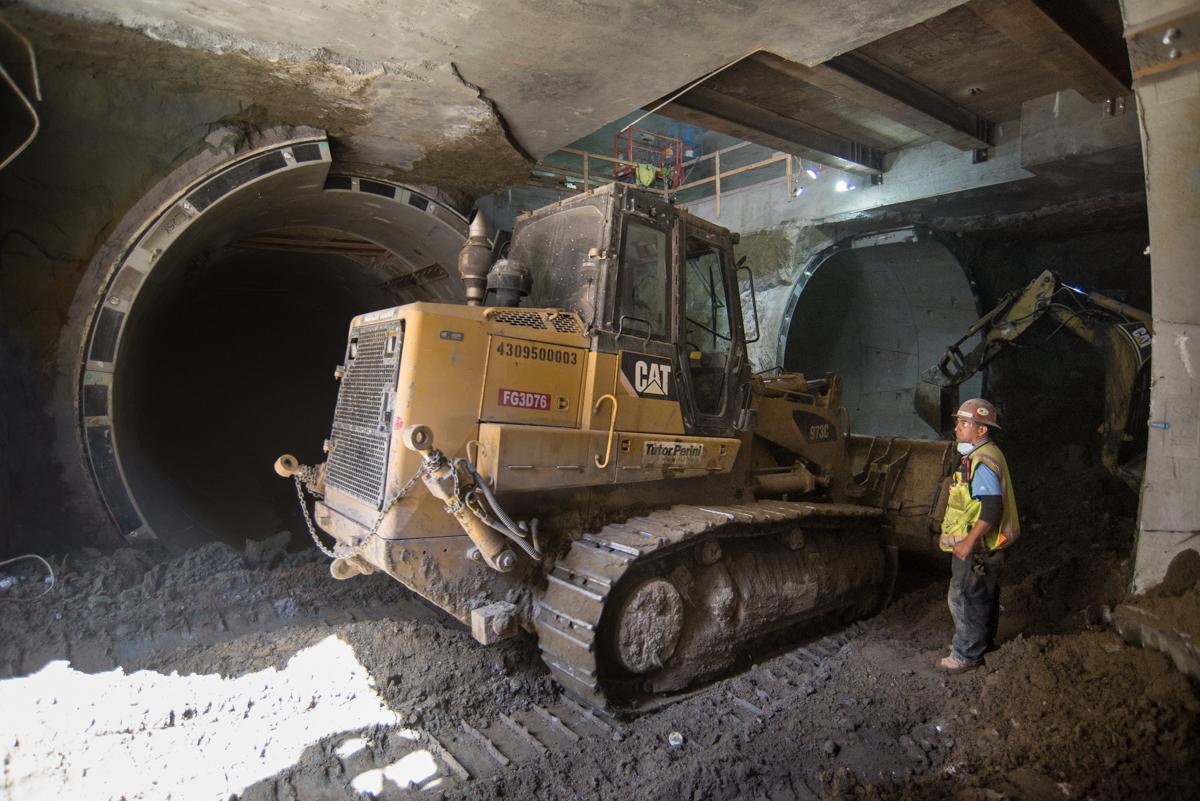 CAT bulldozer positioned at tunnel entrance during Central Subway construction at Yerba Buena/Moscone Station.