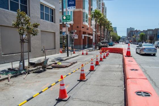 Construction cones and barriers line 4th Street during Central Subway utility work in San Francisco.