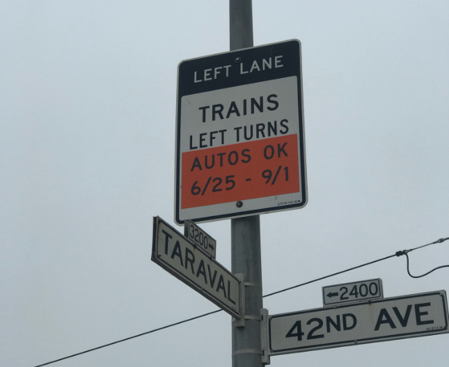 Left lane sign at 42nd Ave and Taraval showing train and left turn restrictions with temporary auto parking allowance dates 6/25-9/1.