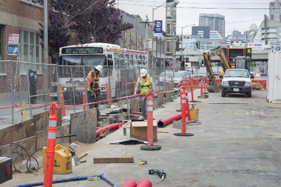 Construction crew excavates trench on 4th Street for Muni ductbank installation.