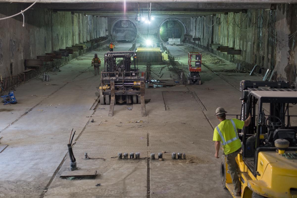 Workers and equipment inside underground tunnel during Central Subway construction at Yerba Buena/Moscone Station.