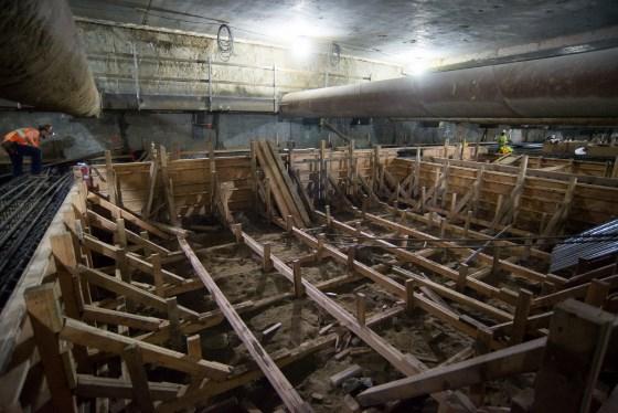 Wooden structural framework and formwork installed underground for concrete pouring at transit station construction site.