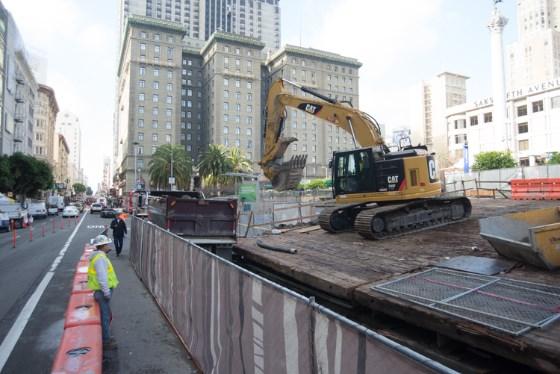 Construction equipment removing Union Square Garage roof section for future transit station entrance on 4th Street.