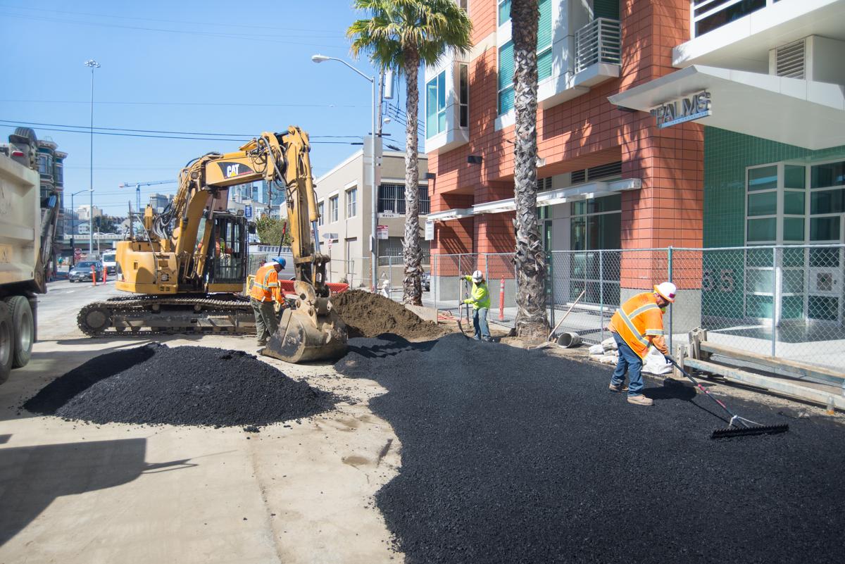 Construction crew repaving street with asphalt near 4th and Bryant