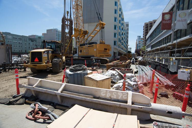 Construction equipment and materials staged at Clementina Alley for underground station construction work.