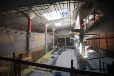 Union Square Garage construction site with single-lane traffic, equipment, and workers visible indoors.