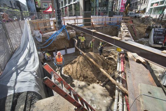 Construction workers install shoring in excavated area at Stockton and Ellis streets downtown.