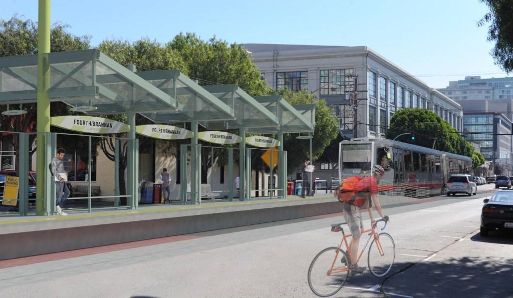 Fourth Street station with transit vehicle, bicycle rider, and storefronts under green canopy structure.