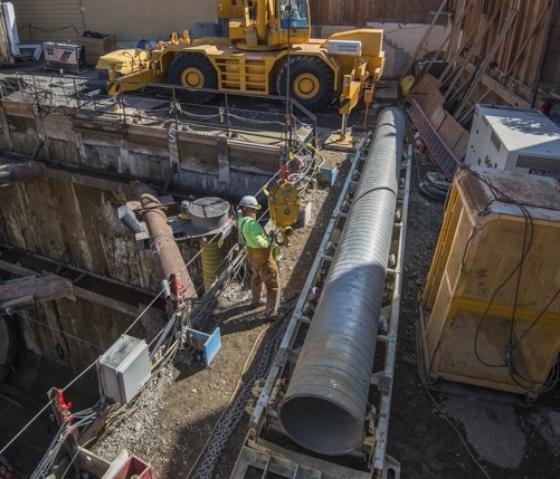 Construction crew removes tunnel boring machine ventilation ductwork at Powell Street site.