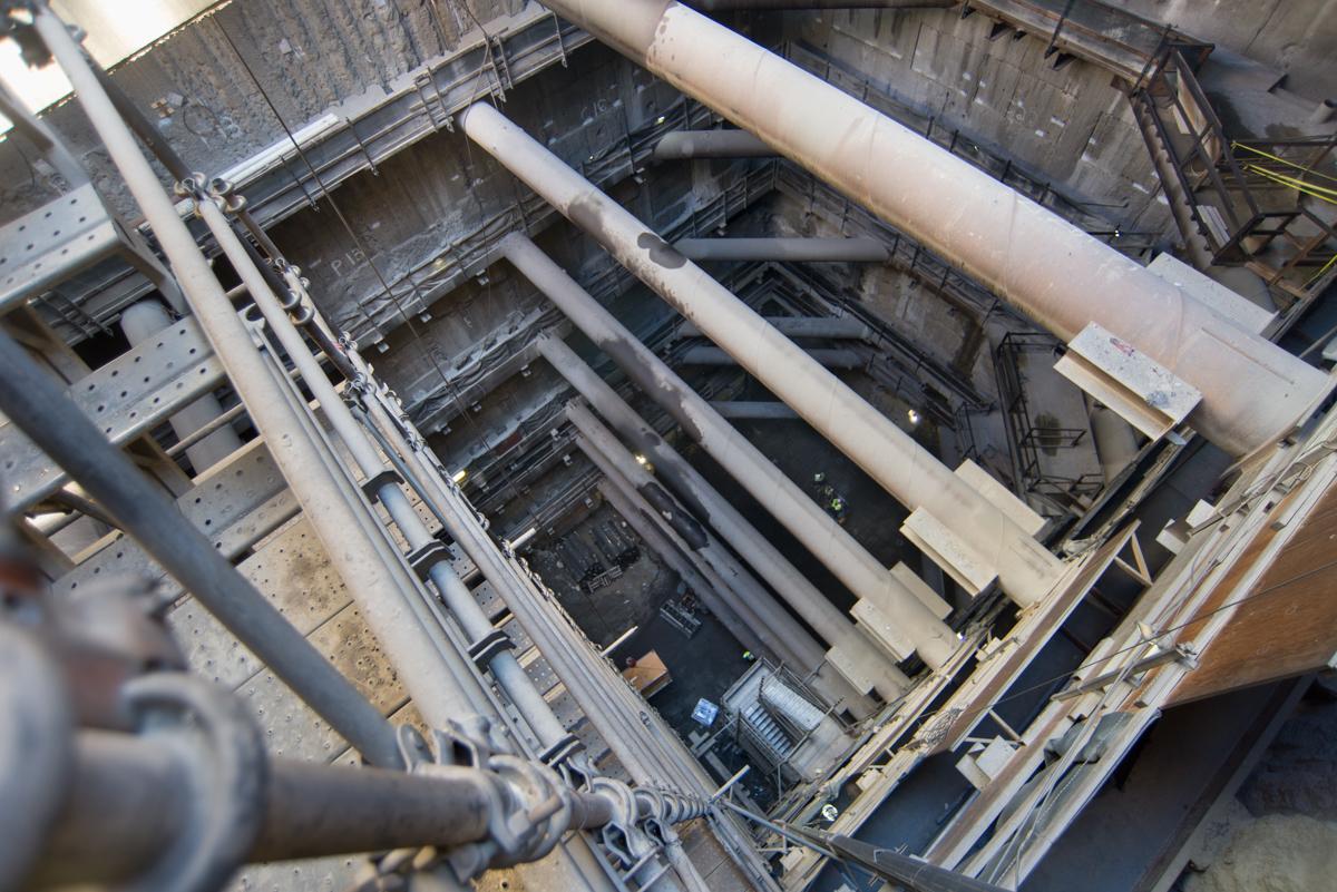 Interior view of station headhouse showing steel reinforcement struts and excavation framework during construction.