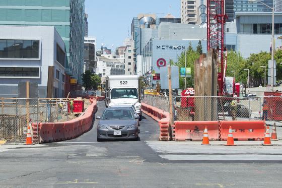 Construction barriers and cones block 4th Street between Howard and Folsom streets during roof deck installation work.