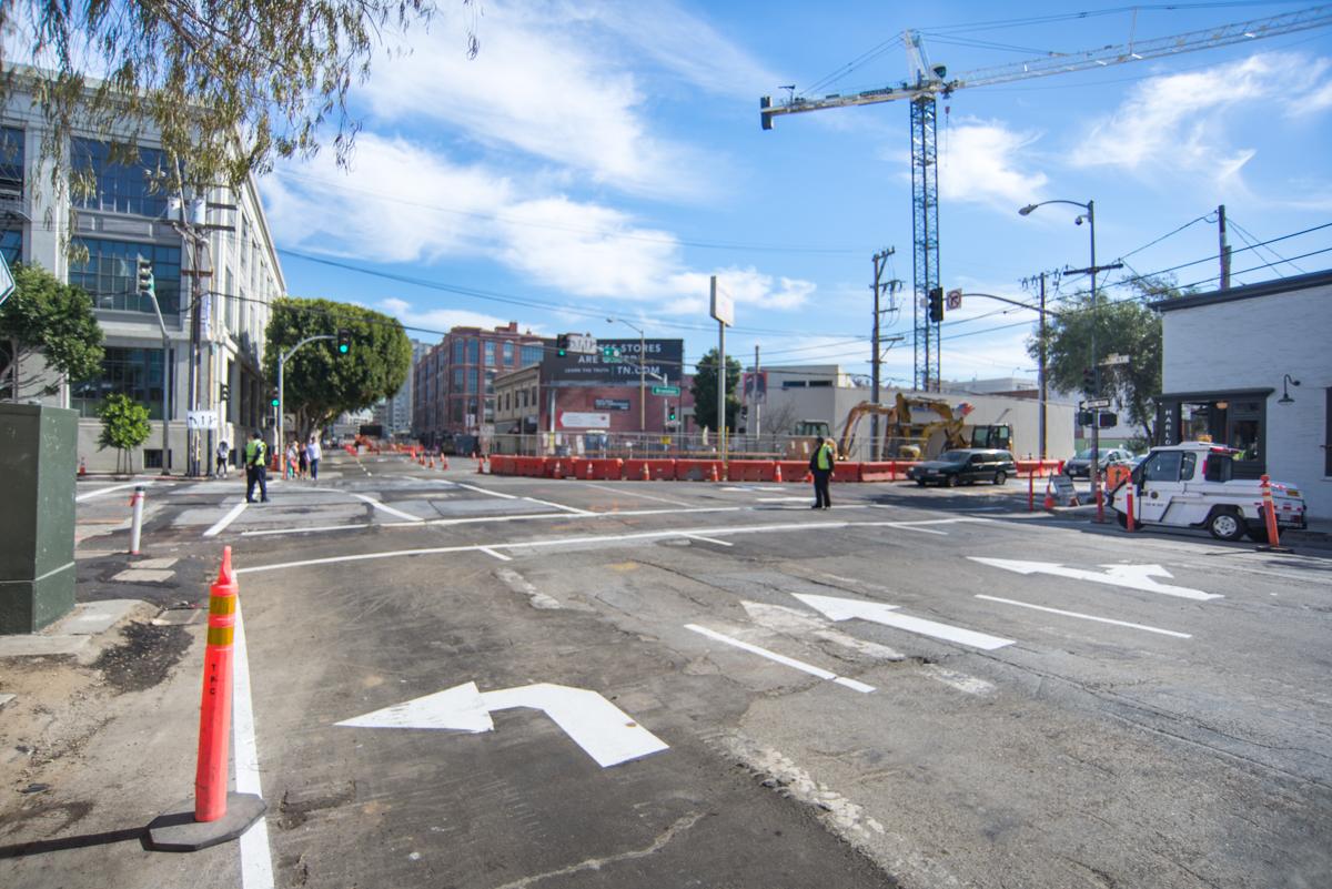 Construction site at 4th and Brannan with traffic cones, lane shifts, and crane overhead.