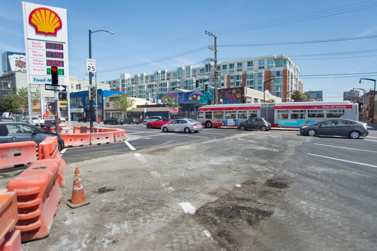 4th and Bryant intersection with construction barriers, Shell gas station, and transit bus on street.