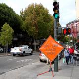 Orange diamond work zone sign on street pole at Columbus Avenue and Union Street intersection.