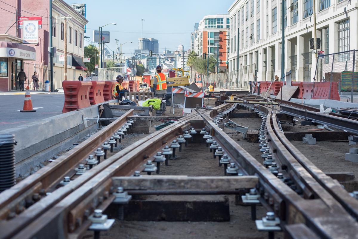 Construction workers install streetcar tracks on 4th Street in San Francisco's SoMa neighborhood.