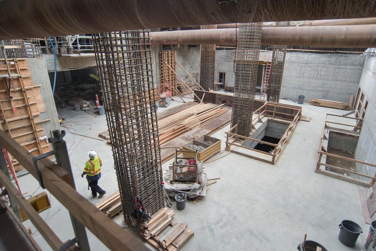 Construction worker in safety gear at Yerba Buena/Moscone station headhouse renovation site.