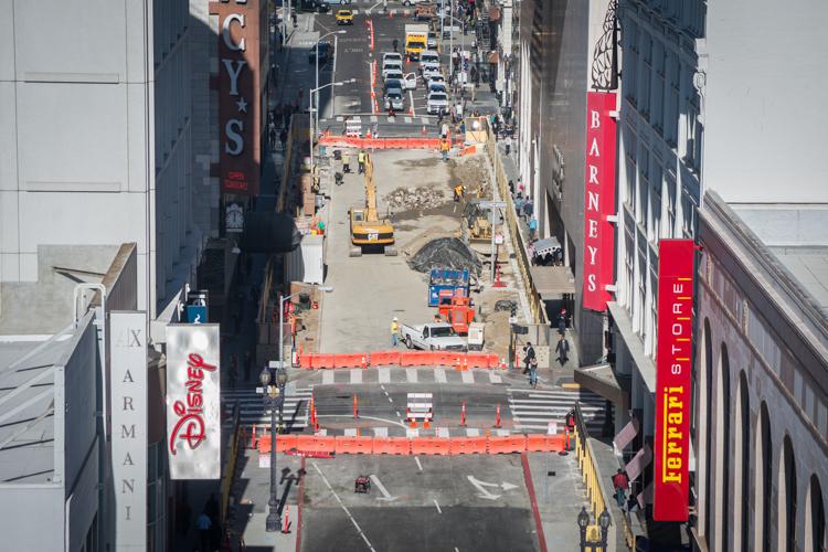 Aerial view of Stockton Street construction site with heavy equipment, barricades, and crews working on pavement removal.
