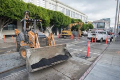 Construction equipment and machinery on 4th Street during utility work near Brannan and Townsend.