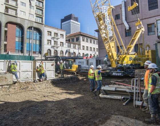 Construction crew and equipment at Chinatown Station site on Stockton Street, San Francisco.