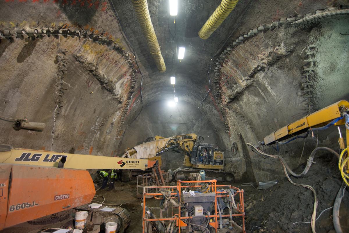 Underground tunnel excavation at Stockton and Washington intersection with construction equipment and machinery.