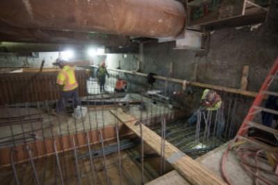 Workers construct rebar cages on underground construction site at 4th Street.
