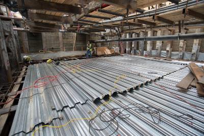 Construction site showing metal floor decking and exposed structural elements inside Union Square Garage.