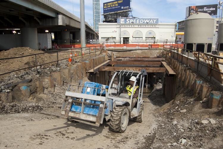 Construction equipment operates in excavated pit for Central Subway project on 4th Street in San Francisco.