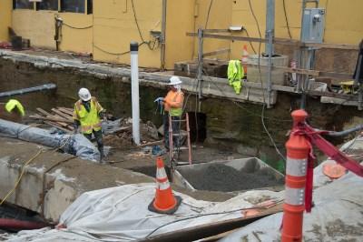 Construction workers performing utility relocation and jet grouting work at Union Square Garage site on Stockton Street.