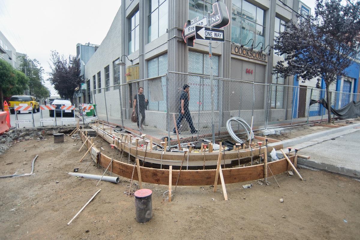 Construction site on 4th Street with wooden forms for new roadbed slab and sidewalk foundations.