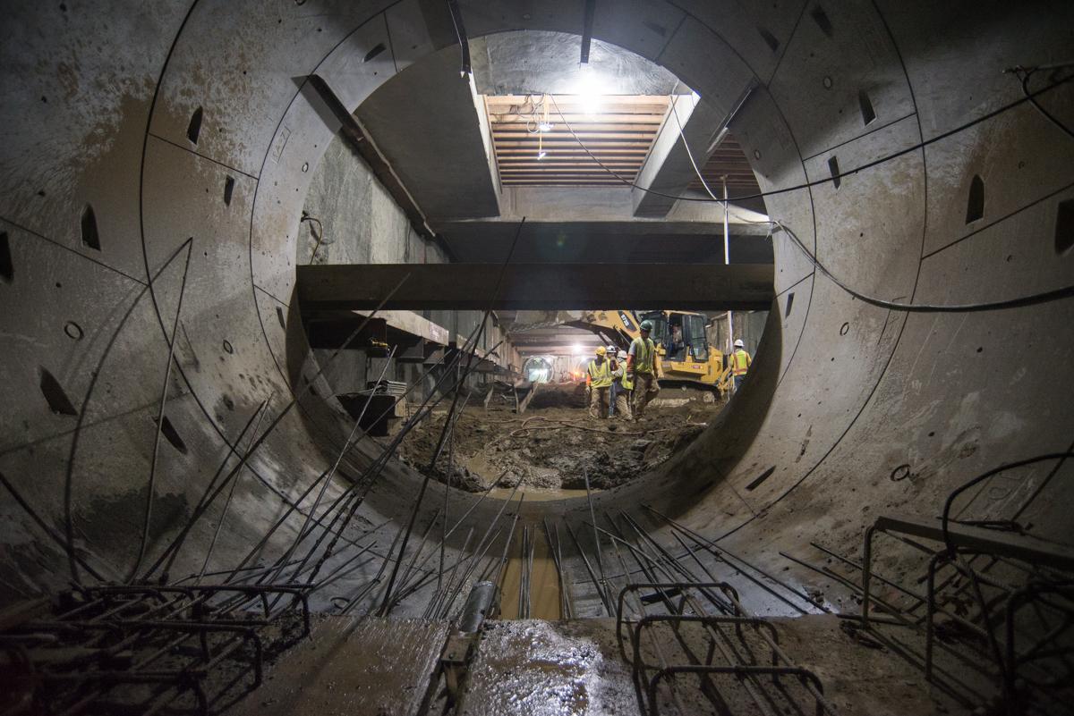 Construction workers install temporary steel bracing inside Yerba Buena/Moscone Station tunnel for Central Subway project.