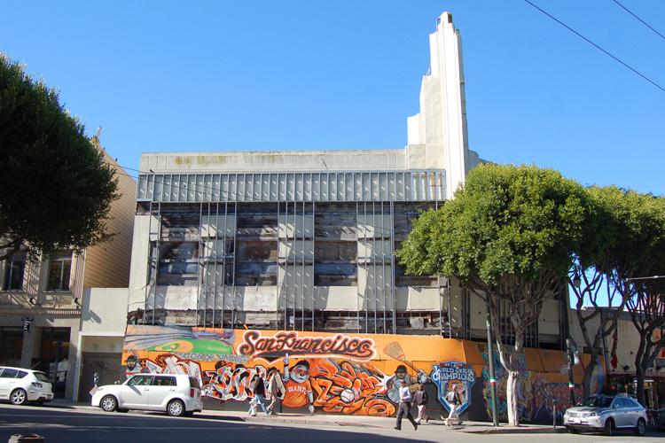 Chinatown Station entrance with white tower and colorful street mural on Stockton Street, San Francisco.