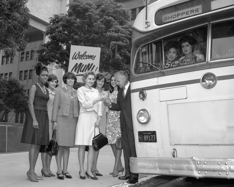 Group of women and man greeting Shoppers Shuttle bus, San Francisco, 1966.