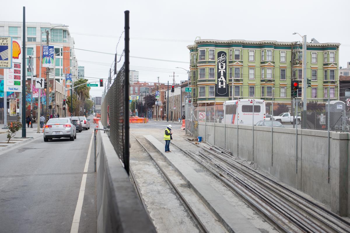 Construction worker in safety vest stands on subway tunnel ramp near 4th and Bryant Street in San Francisco.