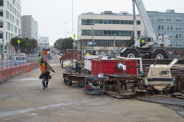 Construction site on 4th Street with equipment, barriers, and workers near Yerba Buena station.