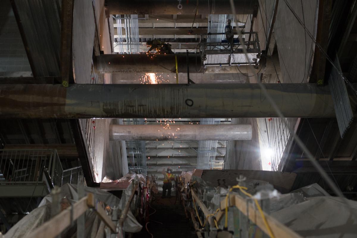 Sparks shower from steel beam welding work at Union Square/Market Street Station.